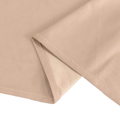 Beige fabric corner with stitched edges on a plain background.