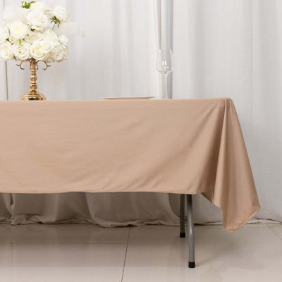 Beige tablecloth draped over a table with elegant decor.