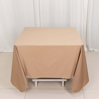Beige tablecloth draped over a table in a studio setting