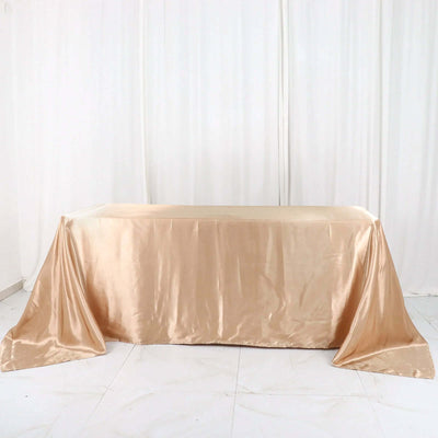 Satin tablecloth in champagne color draped elegantly over a table
