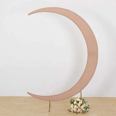 Moon-shaped backdrop in soft pink with floral arrangement