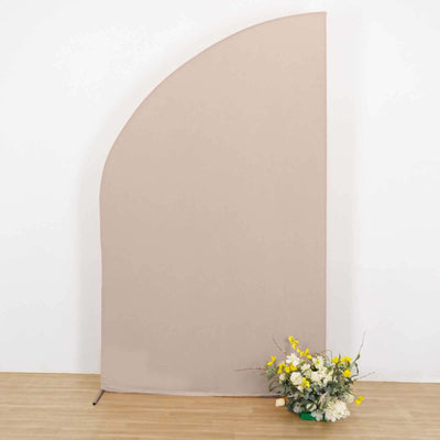 Beige curved backdrop with decorative flowers in front.