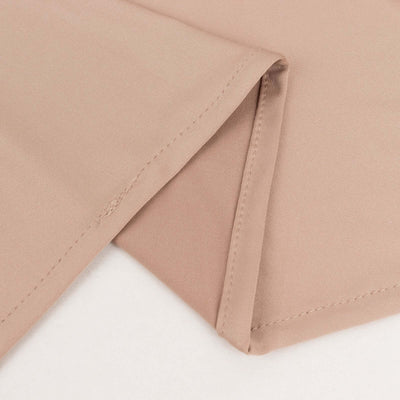 Beige fabric with folded edges, showcasing smooth texture and stitching details.
