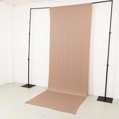 Beige backdrop fabric on a studio stand for photography.