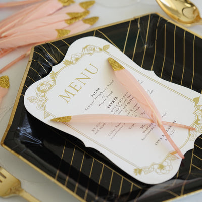 Elegant menu card on a decorative plate with pink accents.
