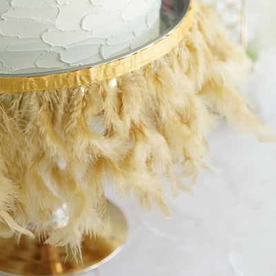 Gold feathered cake stand with textured surface and elegant design.
