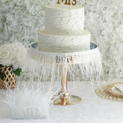 Elegant two-tier wedding cake with textured icing and gold "Mr & Mrs" topper.