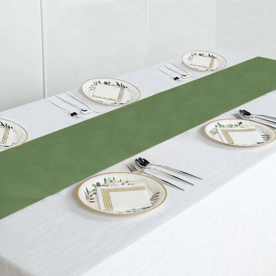 Green table runner on a dining table set with decorative plates and utensils.