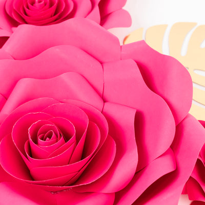 Pink paper roses arrangement on a plain background.