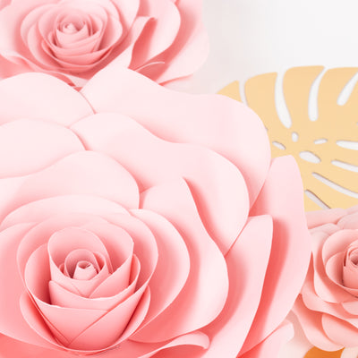 Pink paper roses with intricate details against a light background.