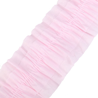 Pink ruffled fabric ribbon on a plain background