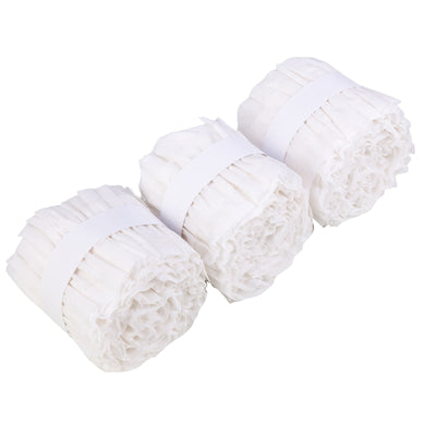Three rolls of white crepe paper streamers on a plain background