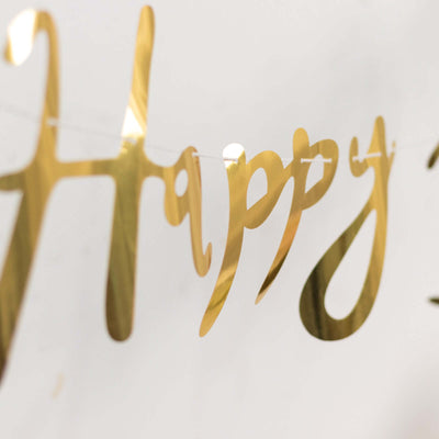 Gold "Happy" banner decoration for celebrations.