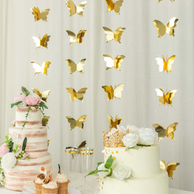 Gold butterfly decorations with tiered cakes for a festive celebration.