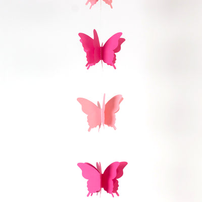 Pink butterfly garland decoration on a white background