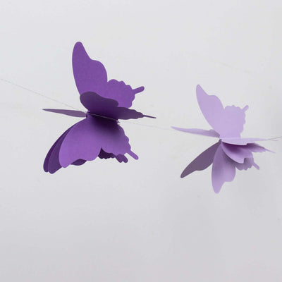Purple paper butterfly garland on a white background