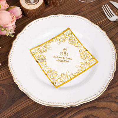 Elegant gold-embellished napkin with custom names and date on a decorative plate.