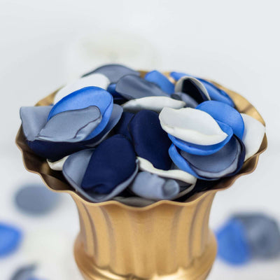 Blue and white satin rose petals in a gold vase.