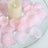 Pink petal candle centerpiece in a glass bowl on a white background