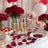 Elegant Valentine's Day dessert table with champagne, roses, and sweet treats.