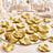 Gold flower petals on a mirrored table centerpiece at an elegant wedding reception