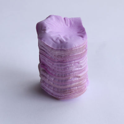 Stack of pink fabric hair scrunchies on a white background