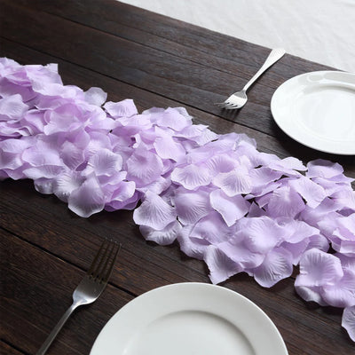 Lavender petal table runner with white plates and forks on dark wood table