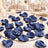 Elegant navy blue flower petals on a mirrored wedding table centerpiece
