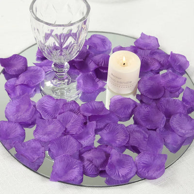 Purple petal table decor with candle and crystal goblet on mirrored tray