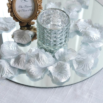 Silver petal candle holder on mirrored tray with glass votive centerpiece