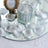 Silver petal candle holder on mirrored tray with glass votive centerpiece