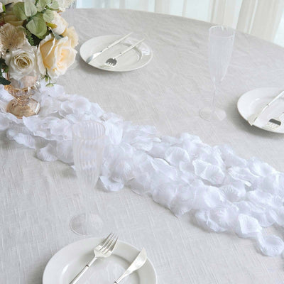 Elegant white floral table setting with roses, plates, and champagne glasses