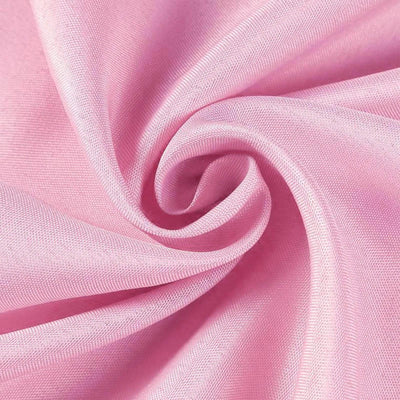 Pink fabric texture swirling in a circular pattern.