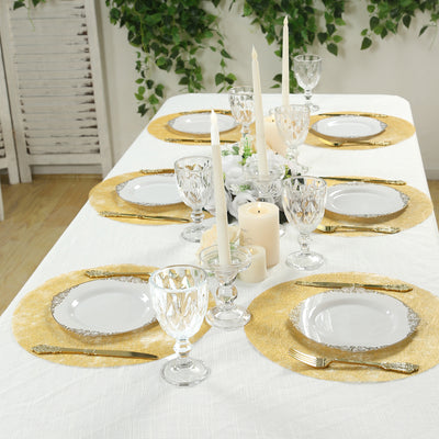 Elegant dining table setting with gold accents and candles.