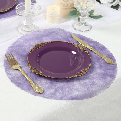 Purple plate with gold trim on a textured purple placemat, elegant table setting.