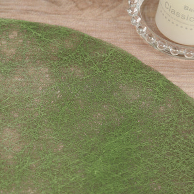 Green decorative mesh fabric on a wooden surface.