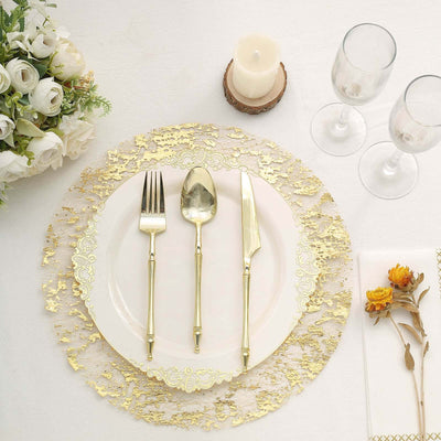 Elegant gold cutlery set on a decorative plate with floral accents.