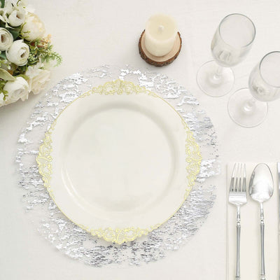 Elegant white plate with gold trim on a decorative silver charger.