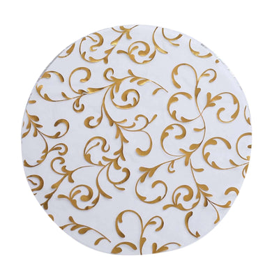 Gold floral patterned round tablecloth on a white background.