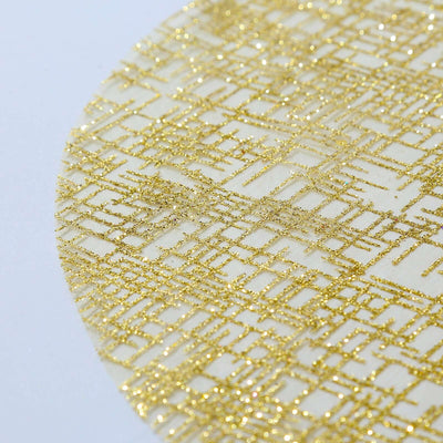 Gold glitter fabric with intricate geometric pattern.