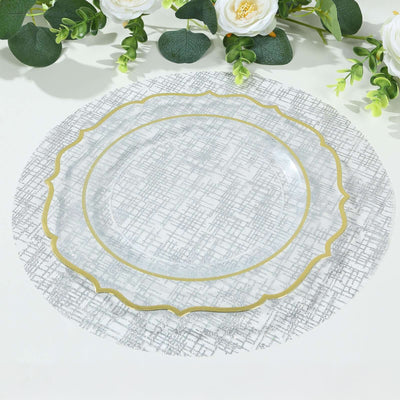 Elegant round plate with gold trim on a textured silver placemat