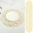 Gold leaf table runner and placemat on a white tablecloth.