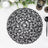 Black decorative placemat with intricate woven design on a marble surface.