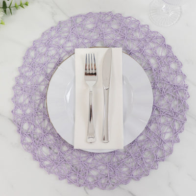 Purple woven placemat with white plate, silver fork, and knife on a marble surface.