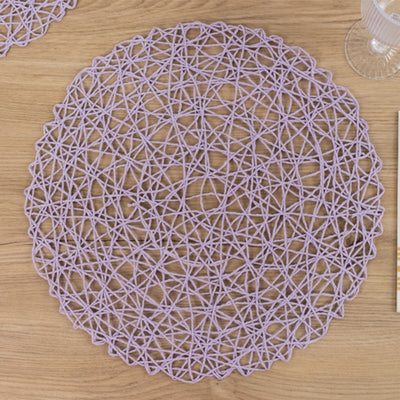 Purple woven placemat on a wooden table.