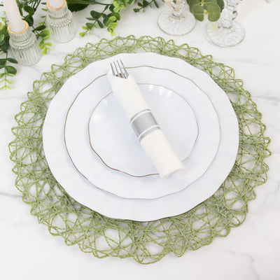 Elegant white dinner plates with a green decorative placemat and napkin.