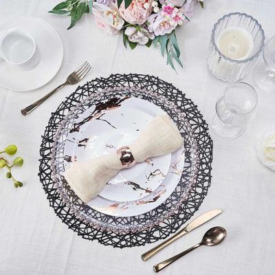 Elegant table setting with marble plates, linen napkin, and floral arrangement.