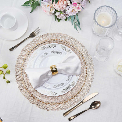 Elegant table setting with a white napkin and floral centerpiece.