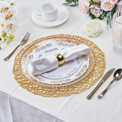 Elegant dining setup with gold-accented tableware and floral decor.