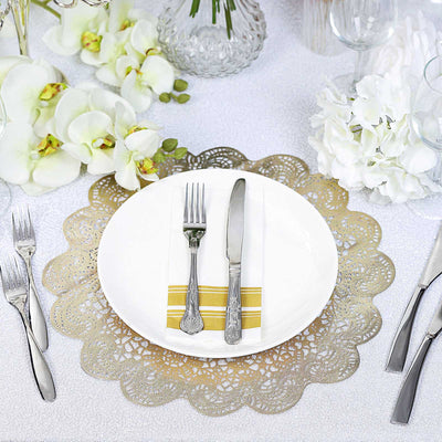Elegant table setting with silver cutlery and decorative plates.